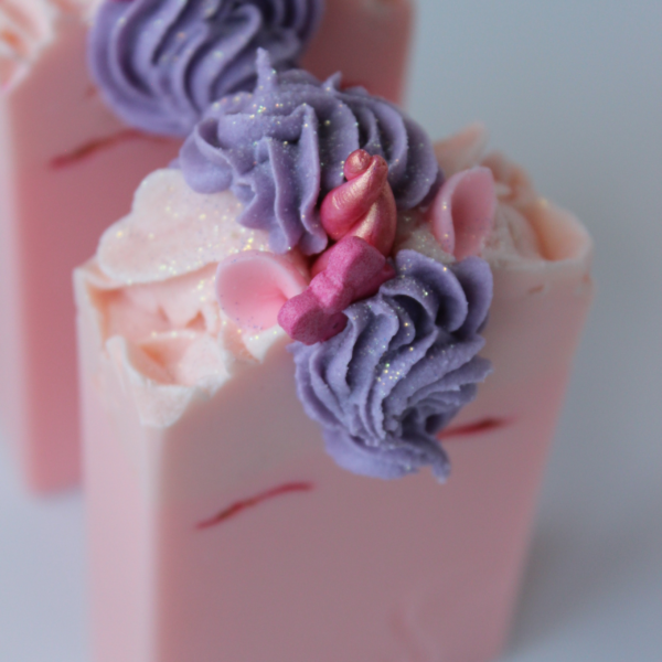 top view of Pink Unicorn Soap with purple piped hair and pink horn