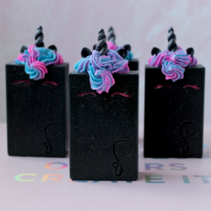 Black unicorn soap with purple and blue piped hair