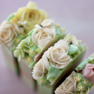 Cut Butterfly whispers soap bar with multi colored piped flowers and soap dough butterflies on top