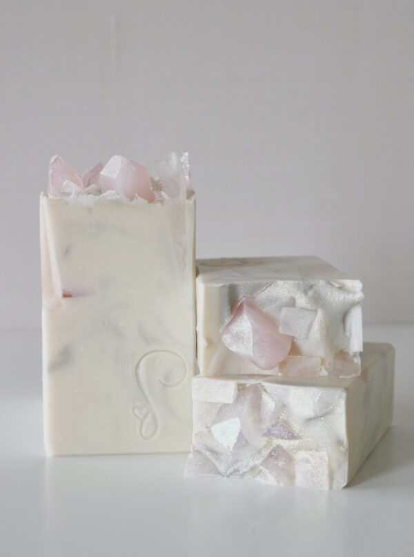 several white soaps with soap rose quartz crystals stacked