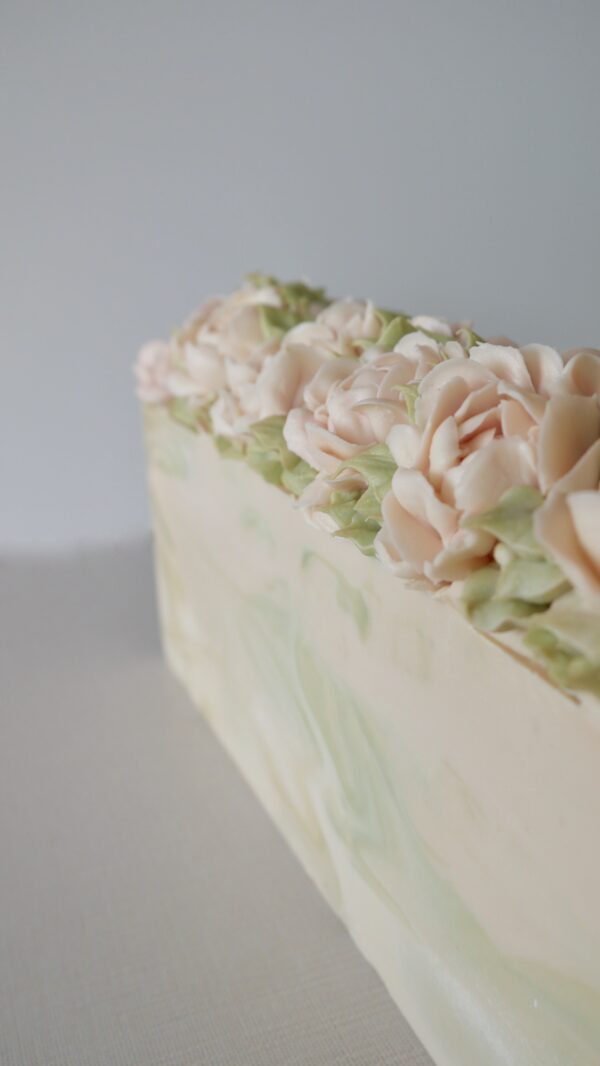 A side view of Pink peony soap showing green swirls inside soap