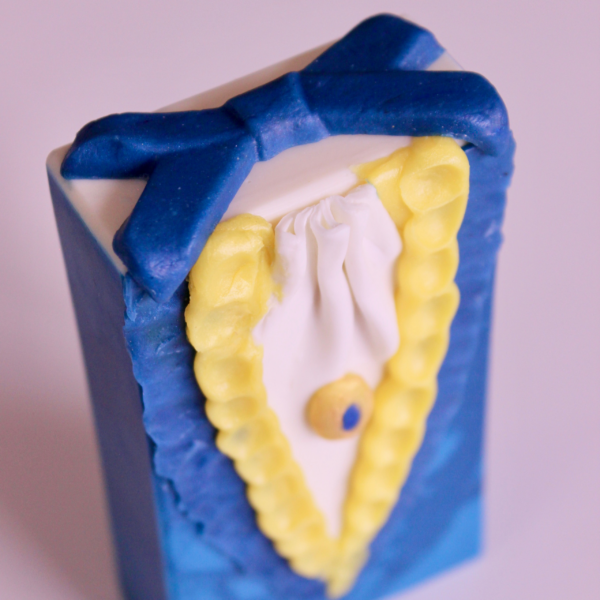 blue and yellow beast soap bar with blue and yellow ruffles and blue bow on top