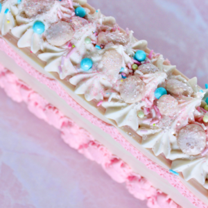 White soap with pink characters on the side and sprinkles on top