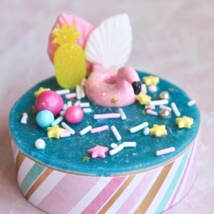 Round soap with blue top sprinkles and soap dough flamingo floatie and fans