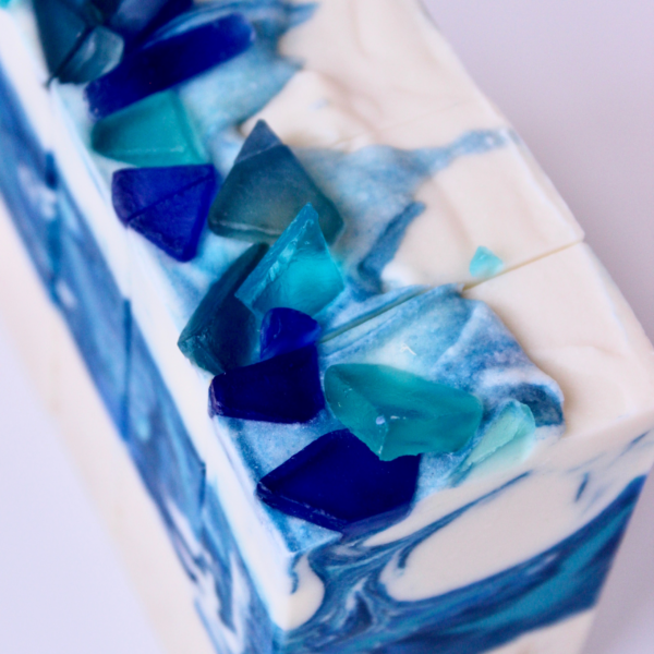Blue and white soap that looks like a wave with texture bottom that looks like sand