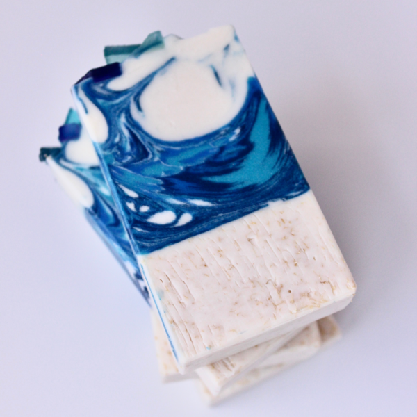 Blue and white soap that looks like a wave with texture bottom that looks like sand
